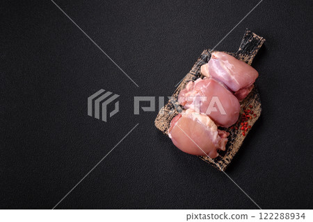 Fresh raw chicken thigh fillets with salt, spices and herbs Fresh raw chicken thigh fillets with salt, spices and herbs 122288934