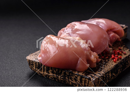 Fresh raw chicken thigh fillets with salt, spices and herbs 122288936