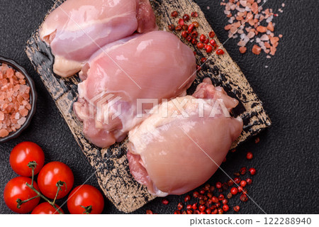Fresh raw chicken thigh fillets with salt, spices and herbs 122288940
