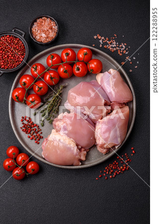 Fresh raw chicken thigh fillets with salt, spices and herbs 122288955