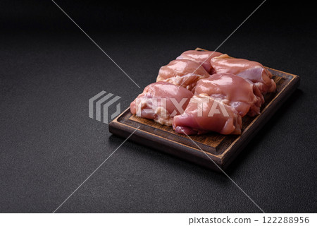Fresh raw chicken thigh fillets with salt, spices and herbs Fresh raw chicken thigh fillets with salt, spices and herbs 122288956