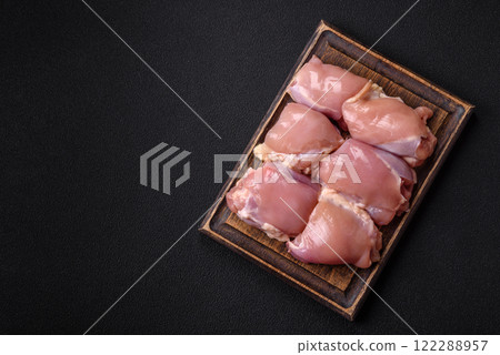 Fresh raw chicken thigh fillets with salt, spices and herbs Fresh raw chicken thigh fillets with salt, spices and herbs 122288957