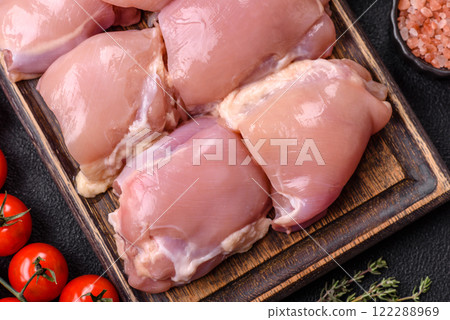 Fresh raw chicken thigh fillets with salt, spices and herbs Fresh raw chicken thigh fillets with salt, spices and herbs 122288969
