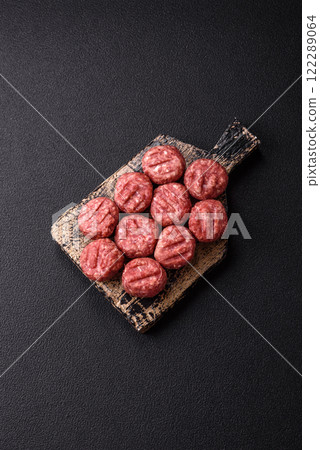 Raw meatballs of minced meat beef, pork or chicken with salt, spices Raw meatballs of minced meat beef, pork or chicken with salt, spices 122289064