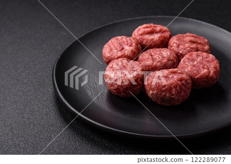 Raw meatballs of minced meat beef, pork or chicken with salt, spices 122289077