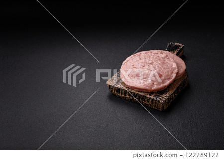 Raw chicken burger cutlet with salt, spices and herbs 122289122