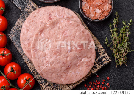 Raw chicken burger cutlet with salt, spices and herbs 122289132