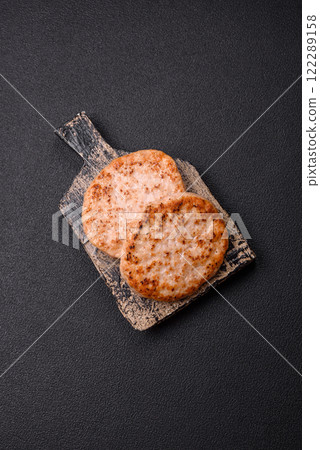 Grilled chicken burger cutlet with salt, spices and herbs Grilled chicken burger cutlet with salt, spices and herbs 122289158