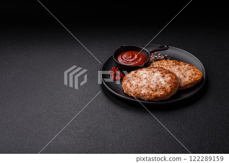 Grilled chicken burger cutlet with salt, spices and herbs Grilled chicken burger cutlet with salt, spices and herbs 122289159
