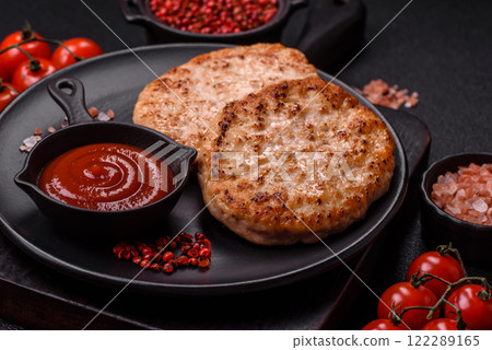 Grilled chicken burger cutlet with salt, spices and herbs Grilled chicken burger cutlet with salt, spices and herbs 122289165