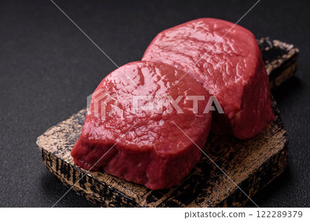 Raw beef eye steak round with salt, spices and herbs 122289379