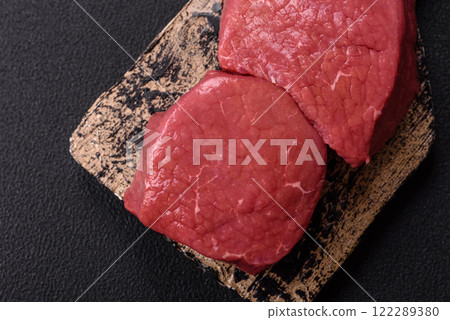 Raw beef eye steak round with salt, spices and herbs Raw beef eye steak round with salt, spices and herbs 122289380