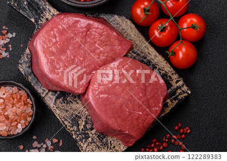 Raw beef eye steak round with salt, spices and herbs 122289383