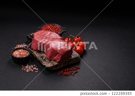 Raw beef eye steak round with salt, spices and herbs 122289385