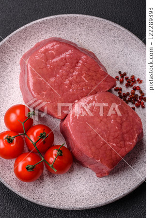 Raw beef eye steak round with salt, spices and herbs Raw beef eye steak round with salt, spices and herbs 122289393