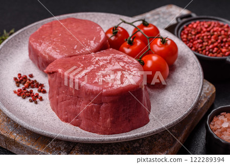 Raw beef eye steak round with salt, spices and herbs 122289394