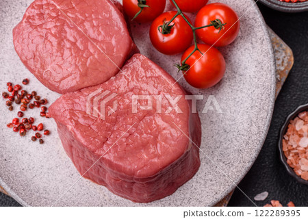 Raw beef eye steak round with salt, spices and herbs Raw beef eye steak round with salt, spices and herbs 122289395