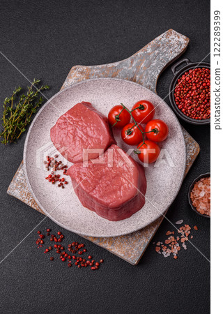 Raw beef eye steak round with salt, spices and herbs Raw beef eye steak round with salt, spices and herbs 122289399