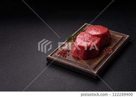 Raw beef eye steak round with salt, spices and herbs Raw beef eye steak round with salt, spices and herbs 122289400