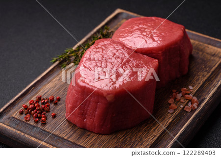 Raw beef eye steak round with salt, spices and herbs 122289403