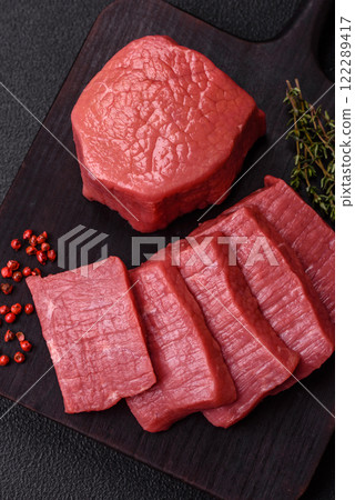 Juicy raw beef cut into slices with salt and spices Juicy raw beef cut into slices with salt and spices 122289417