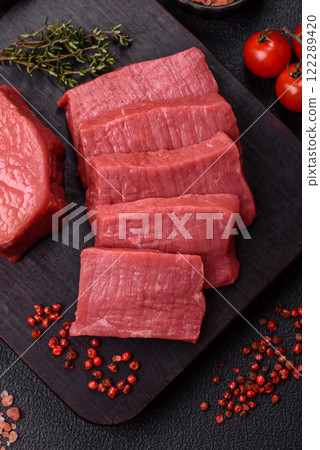 Juicy raw beef cut into slices with salt and spices Juicy raw beef cut into slices with salt and spices 122289420