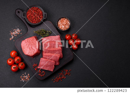 Juicy raw beef cut into slices with salt and spices Juicy raw beef cut into slices with salt and spices 122289423