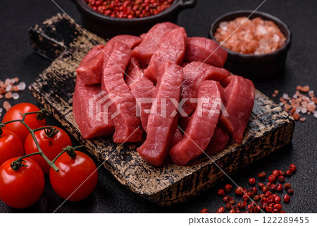 Juicy raw beef cut into slices with salt and spices Juicy raw beef cut into slices with salt and spices 122289455