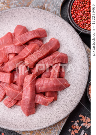 Juicy raw beef cut into slices with salt and spices 122289469