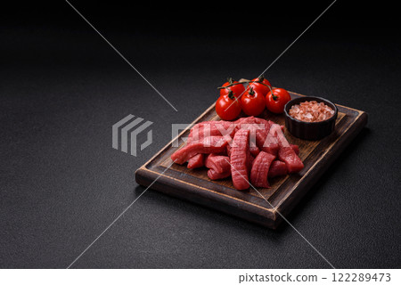 Juicy raw beef cut into slices with salt and spices 122289473