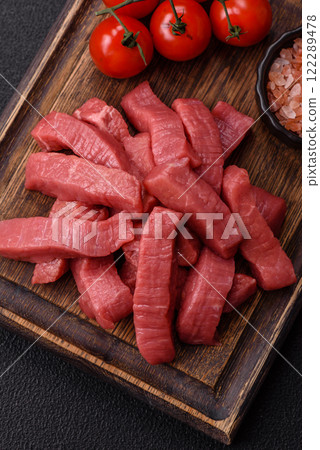 Juicy raw beef cut into slices with salt and spices Juicy raw beef cut into slices with salt and spices 122289478