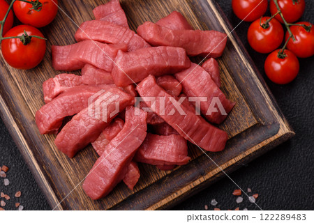 Juicy raw beef cut into slices with salt and spices 122289483