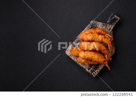 Hot crispy shrimp breaded with salt and spices with white sauce Hot crispy shrimp breaded with salt and spices with white sauce 122289541