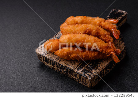 Hot crispy shrimp breaded with salt and spices with white sauce 122289543