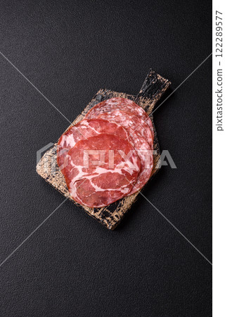Antipasto jamon, prosciutto, sausage, sliced with tomatoes, salt and spices Antipasto jamon, prosciutto, sausage, sliced with tomatoes, salt and spices 122289577