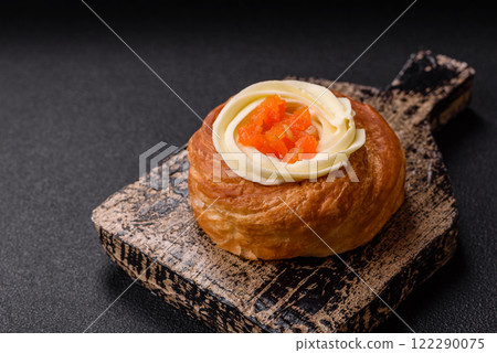 Sweet dessert danish covered with white cream and citrus, with cream filling Sweet dessert danish covered with white cream and citrus, with cream filling 122290075