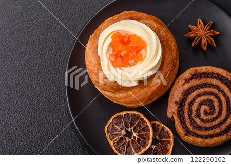 Sweet dessert danish covered with white cream and citrus, with cream filling Sweet dessert danish covered with white cream and citrus, with cream filling 122290102