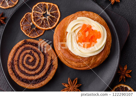 Sweet dessert danish covered with white cream and citrus, with cream filling Sweet dessert danish covered with white cream and citrus, with cream filling 122290107