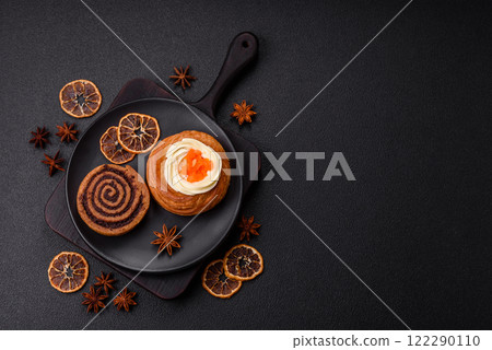 Sweet dessert danish covered with white cream and citrus, with cream filling 122290110