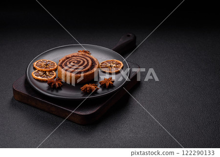Freshly baked cinnamon roll with spices and cocoa filling Freshly baked cinnamon roll with spices and cocoa filling 122290133