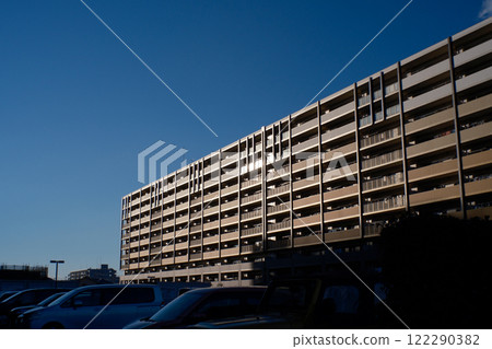 A large apartment building on a clear, blue day 122290382