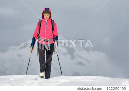 A young woman alone on a winter hike 122290403