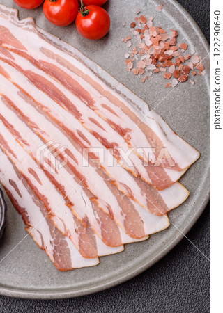 Fresh raw bacon sliced with spices and herbs Fresh raw bacon sliced with spices and herbs 122290640
