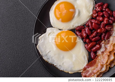 English breakfast with fried eggs, bacon, beans, tomatoes, spices and herbs 122290695