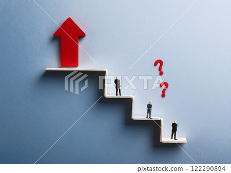 A miniature figure of a businessman thinking about how to get up 122290894