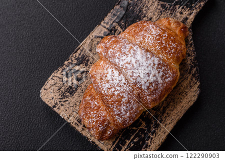 Fresh crispy sweet croissant with chocolate filling 122290903