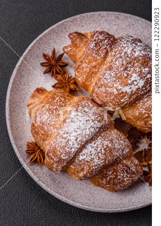 Fresh crispy sweet croissant with chocolate filling 122290923
