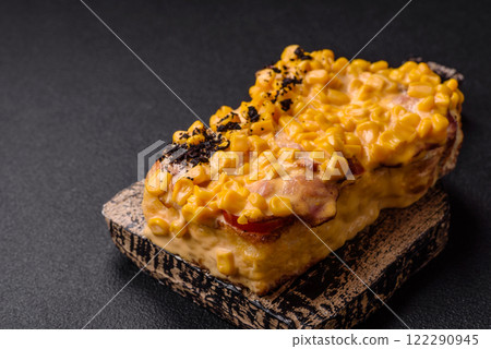 Sandwich with brioche, meat, melted cheese, corn, salt, spices and herbs 122290945