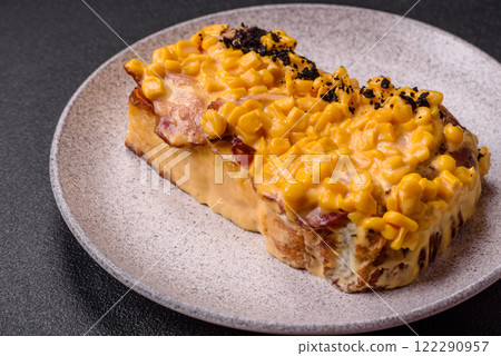 Sandwich with brioche, meat, melted cheese, corn, salt, spices and herbs 122290957