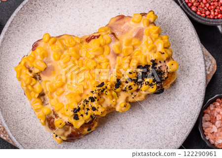 Sandwich with brioche, meat, melted cheese, corn, salt, spices and herbs 122290961